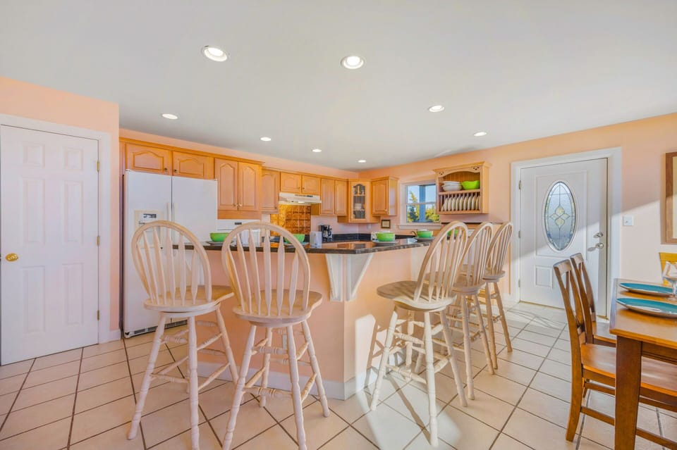 Your fully equipped kitchen invites culinary adventures with ample counter space, modern appliances, and a breakfast bar perfect for morning coffee.