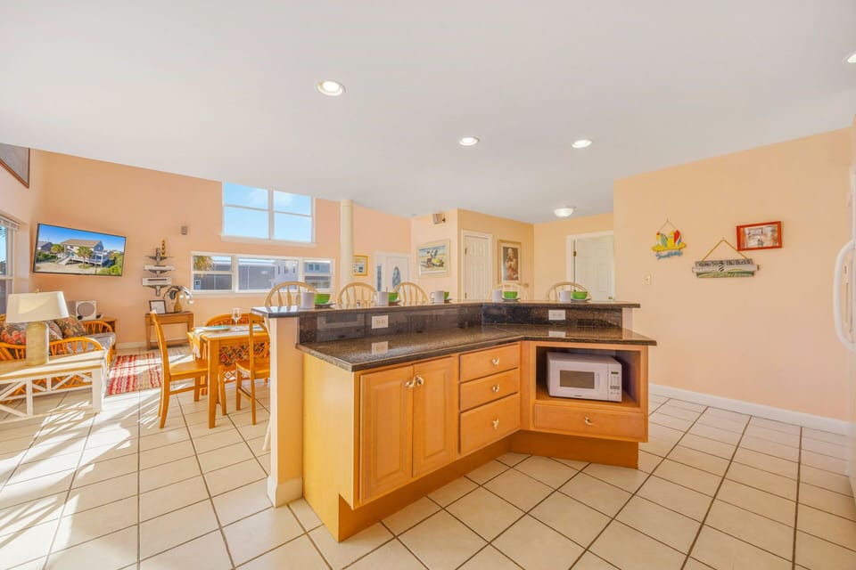 Your spacious kitchen flows seamlessly into a bright dining area, featuring granite countertops and everything you need to create memorable meals together.