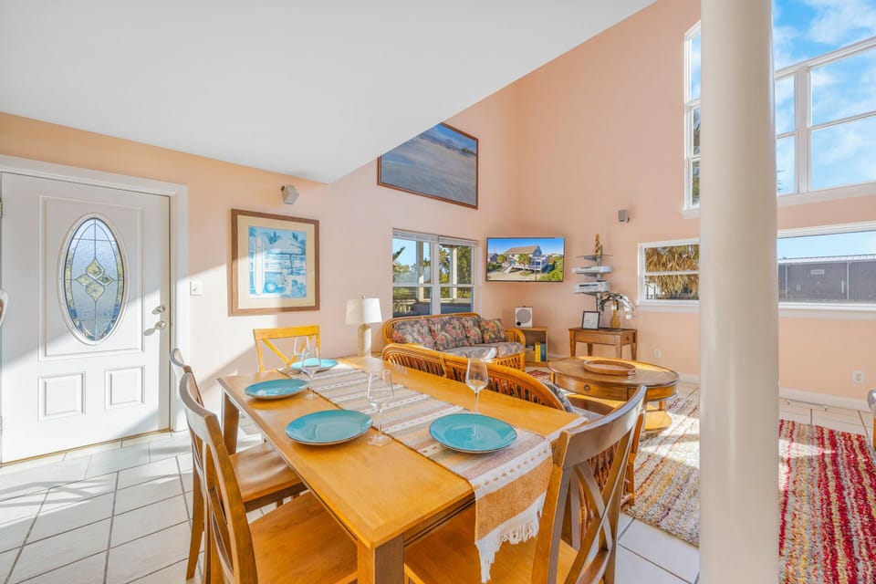 Step into your bright, open living space where natural light pours through skylights and windows, creating the perfect atmosphere for memorable meals together.