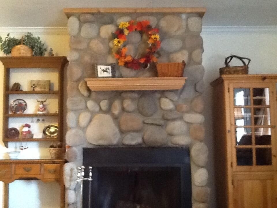 River Rock fireplace with firewood provided.