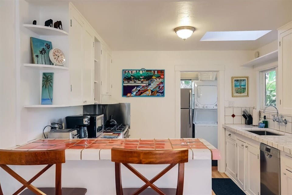 Breakfast bar seating looking into kitchen and laundry area in back.