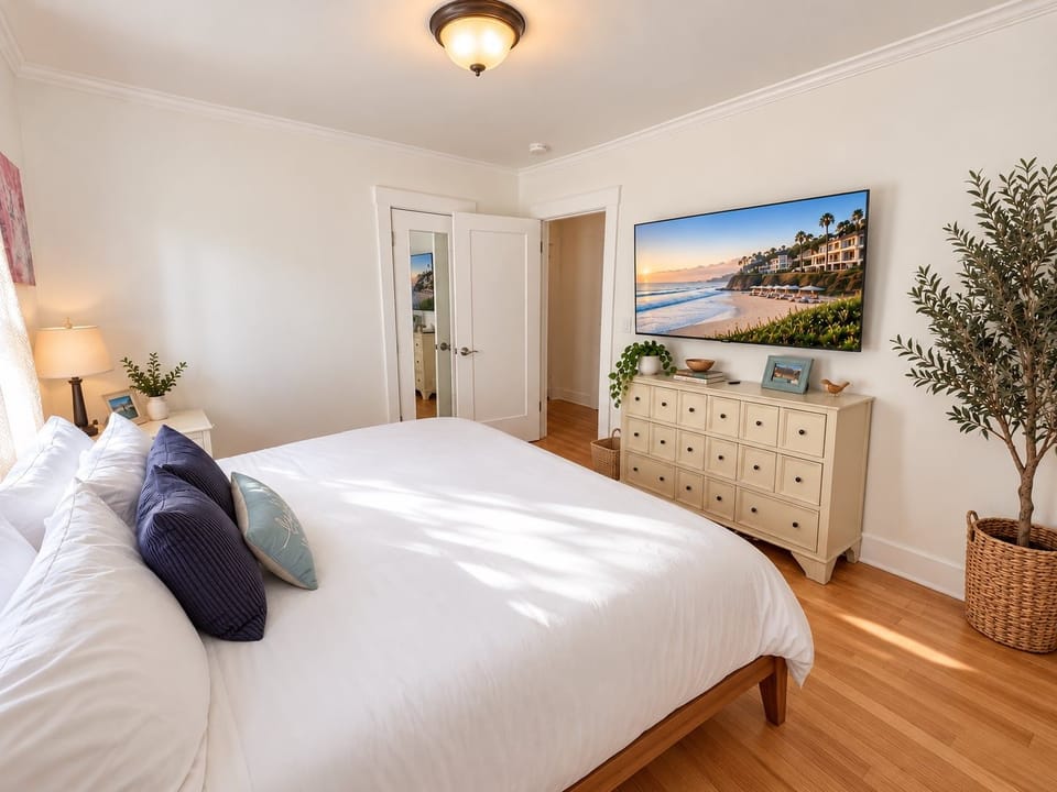 Guest bedroom offers nice closet and a comfortable king bed along with TV and lots of natural light