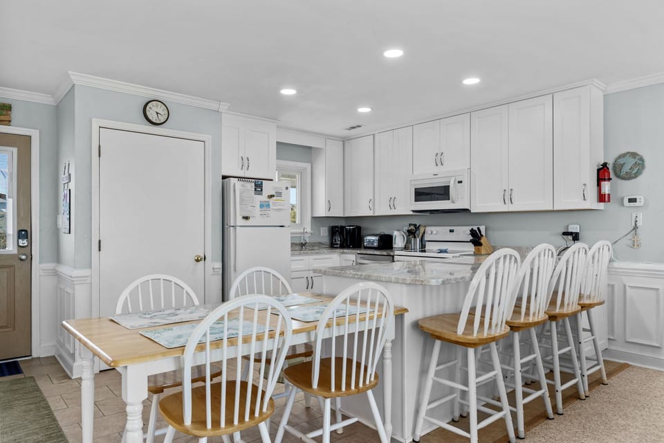 Your spacious kitchen features granite countertops, modern appliances, and comfortable seating for eight, perfect for group meals and morning coffee.