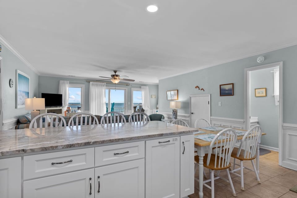 Your spacious kitchen flows into the dining area where ocean views create the perfect backdrop for memorable meals together.