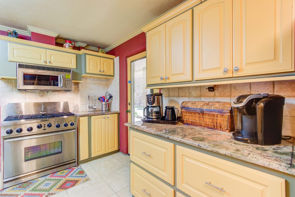 Beautiful granite counter tops throughout kitchen, two coffee makers.