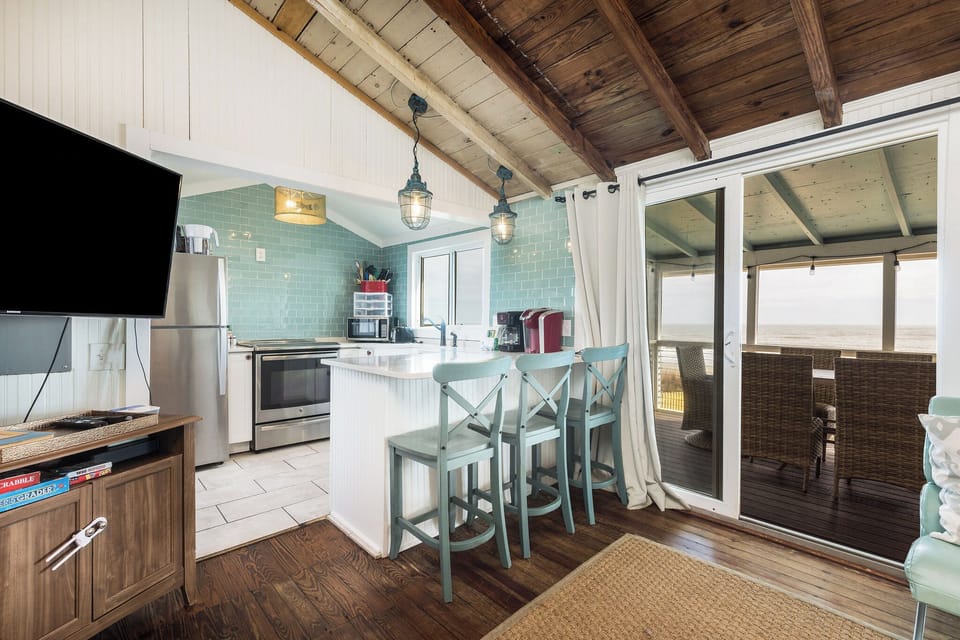 Your kitchen is equipped with stainless steel appliances and views of the ocean