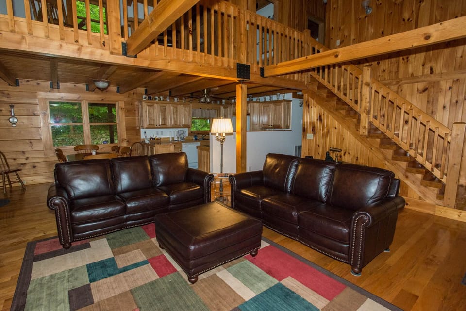 Vaulted living area with gas fireplace, TV, and comfortable gathering space