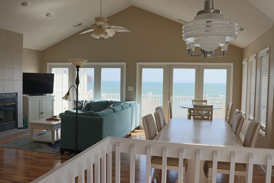 Relax in your bright open living space where ocean views frame every moment through soaring windows.