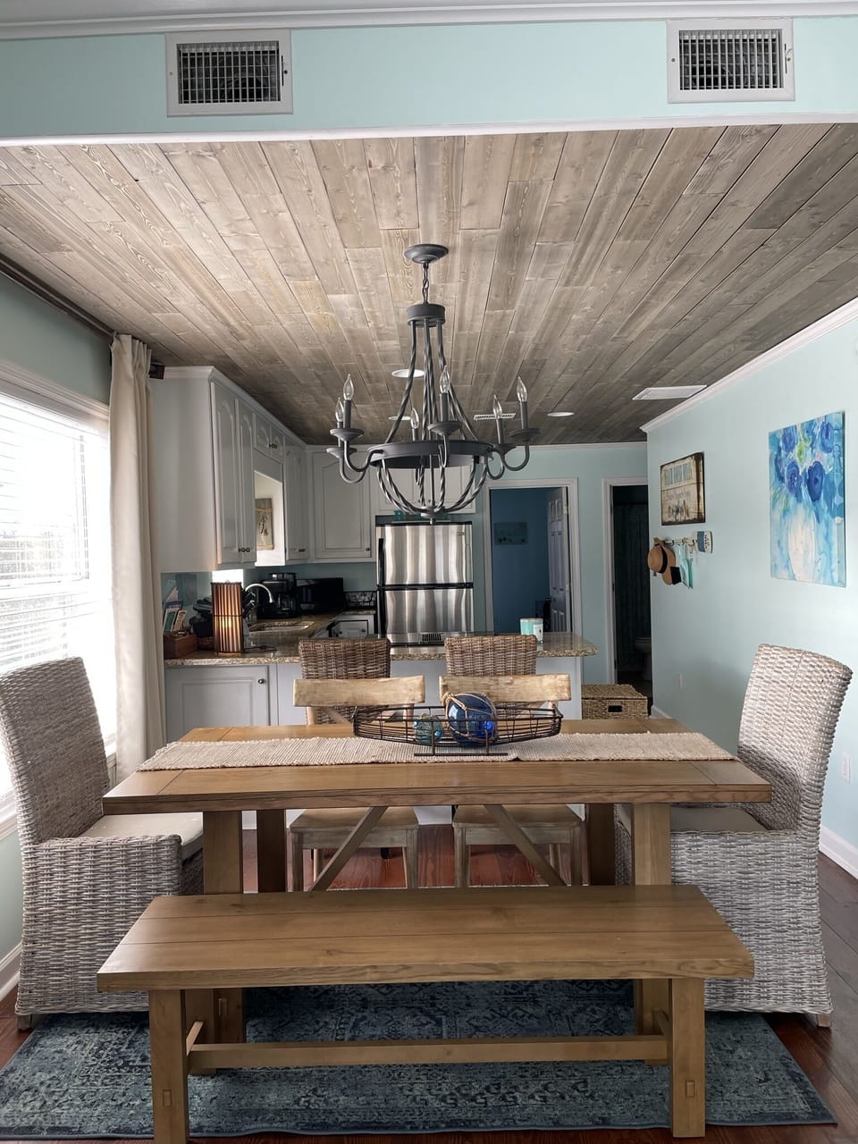 Dining area with kitchen in the background.