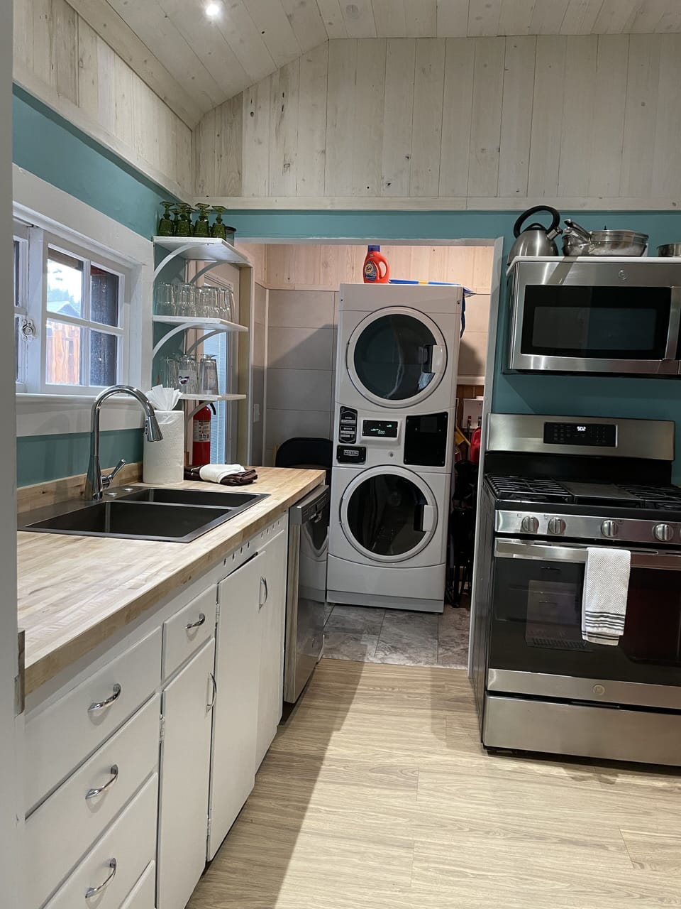 kitchen looking into laundry w/ free commercial size washer and dryer. 