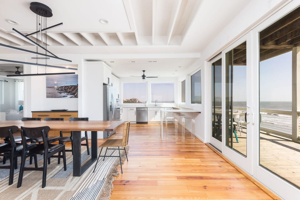 Bright dining area with sliding doors to a breezy deck