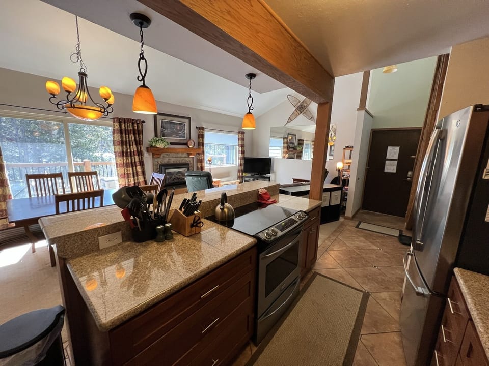 Kitchen and dining room with open floor plan and door to deck.