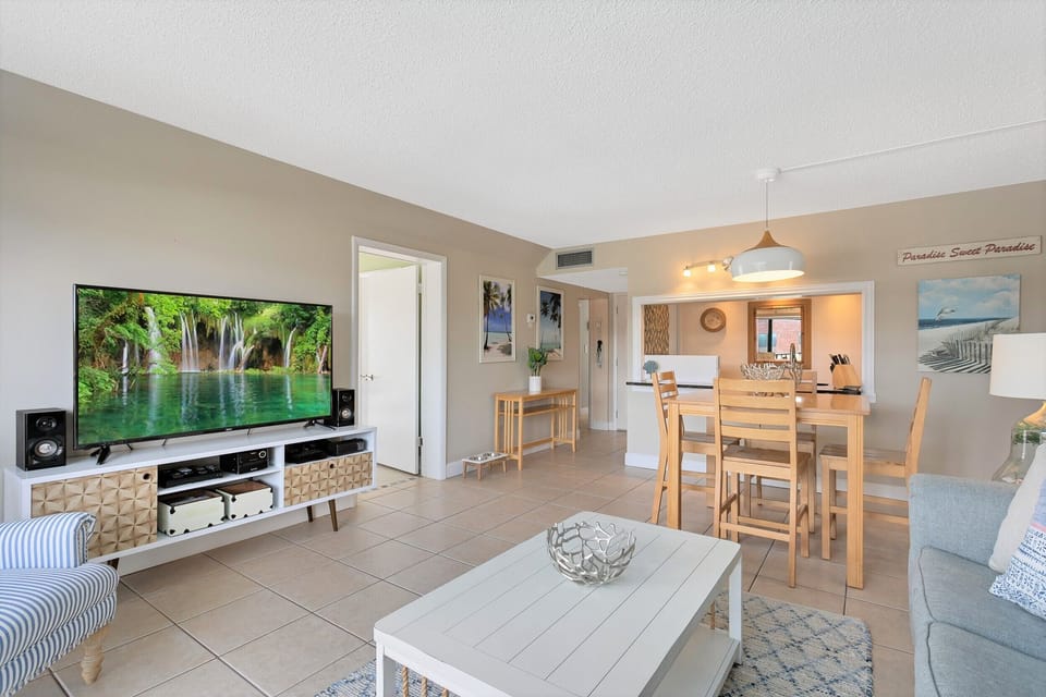 Spacious living area with modern entertainment setup and cozy ambiance.