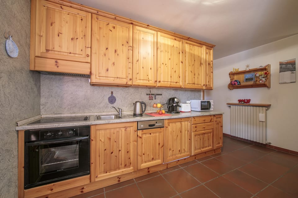 Kitchen with oven, induction hob, kettle, coffee machine and dishwasher