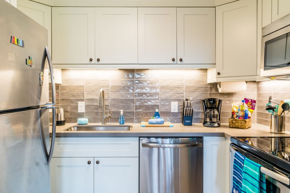 NEW Modern kitchen with Textured backsplash and Refined quartz countertops.