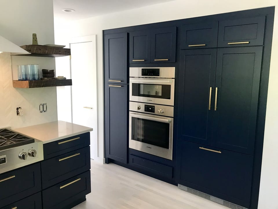 Chef's kitchen with built in fridge and wall ovens