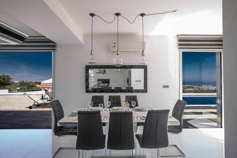 Dining area with large patio doors leading to the garden and pool