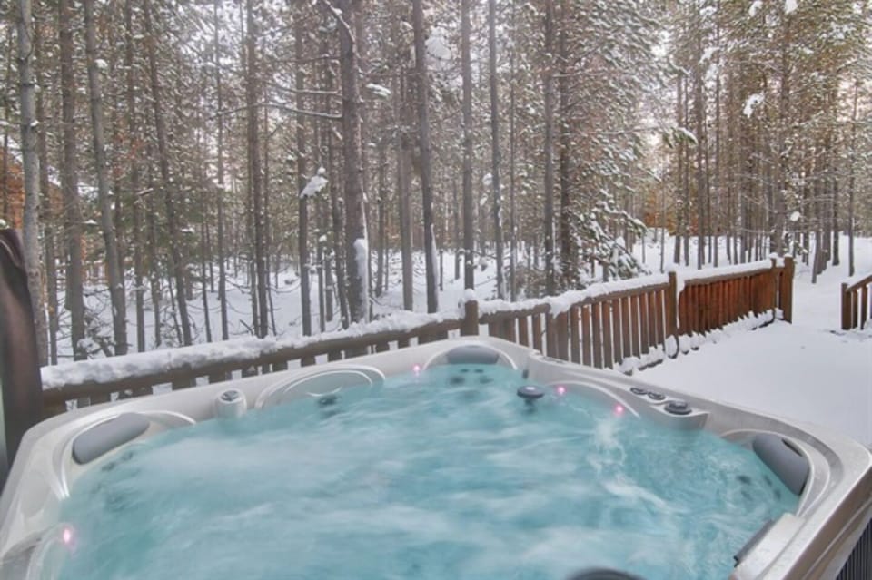 Relax in the outdoor hot tub while enjoying breathtaking views.