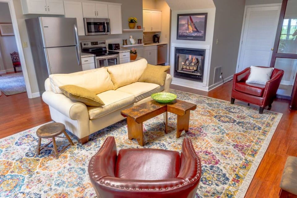 Comfortable living room with full kitchen along wall and romantic gas fireplace