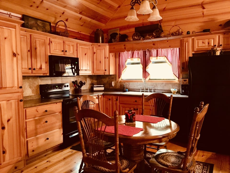 The well equipped kitchen has a glass top range, farm sink, and a dishwasher.