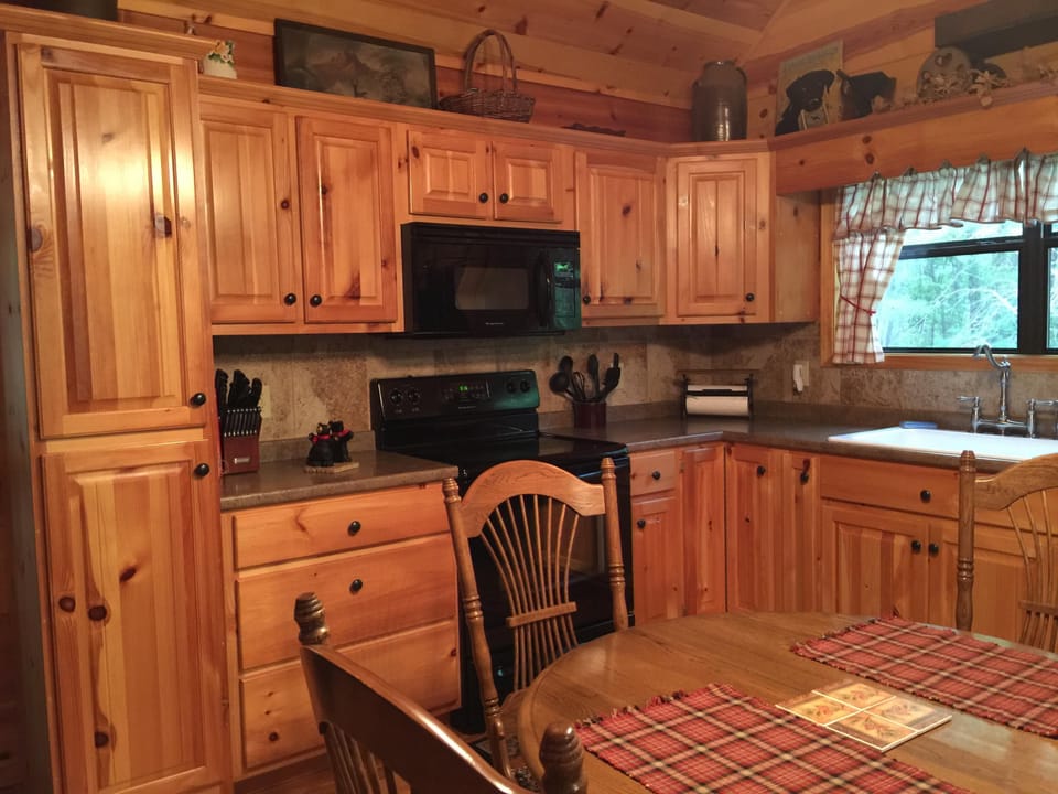 Solid wood cabinets with tile back splash
well equipped to make simple meals