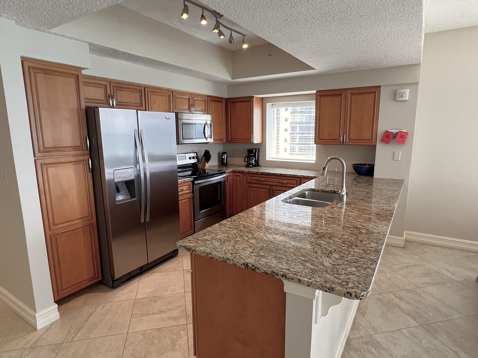 Fully stocked kitchen with custom maple cabinets.