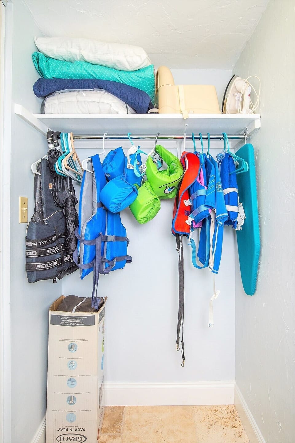 life jackets, swimmies, ironing  board, pac n play