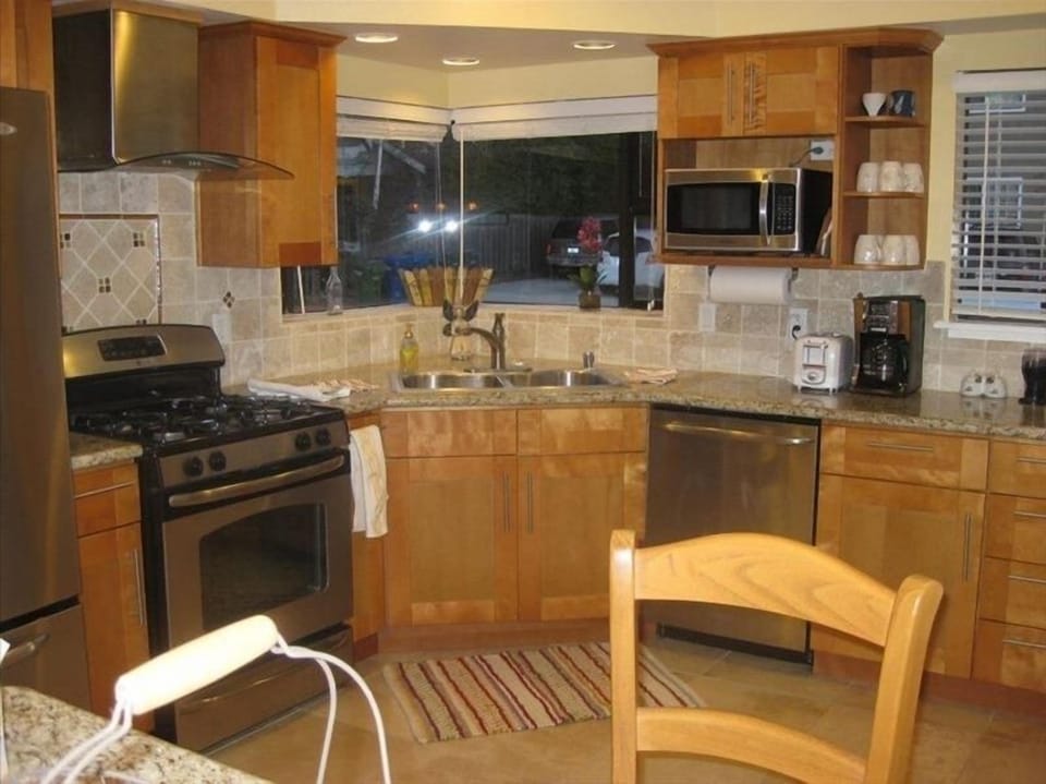 Well appointed kitchen with granite counters and stainless steel appliances