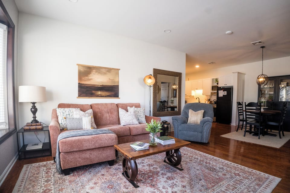 Cozy living room with large bay windows & high ceilings, plenty of natural light