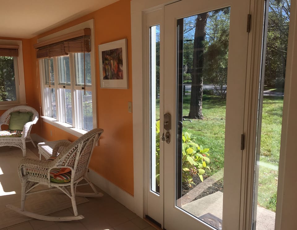Glass front door with screen brings in light and cool evening breeze.