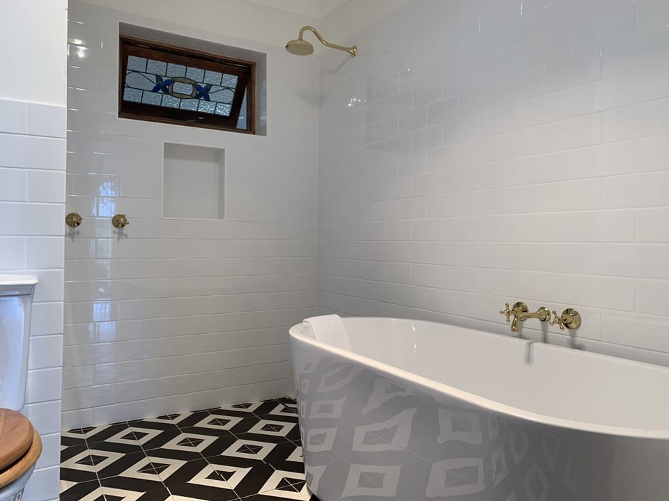 Gorgeous bathroom with deep bath, period window and shower