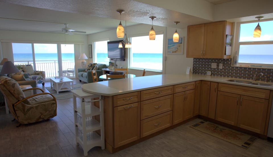 Overlook of kitchen, dining area, and living room