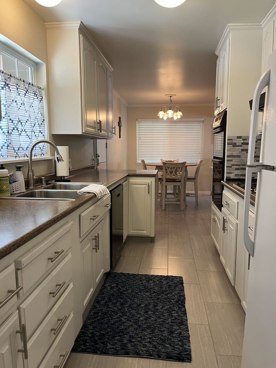Galley kitchen flows to homes entry and dining table and family room...