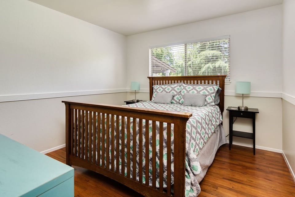 Bedroom one with queen mission style bed.