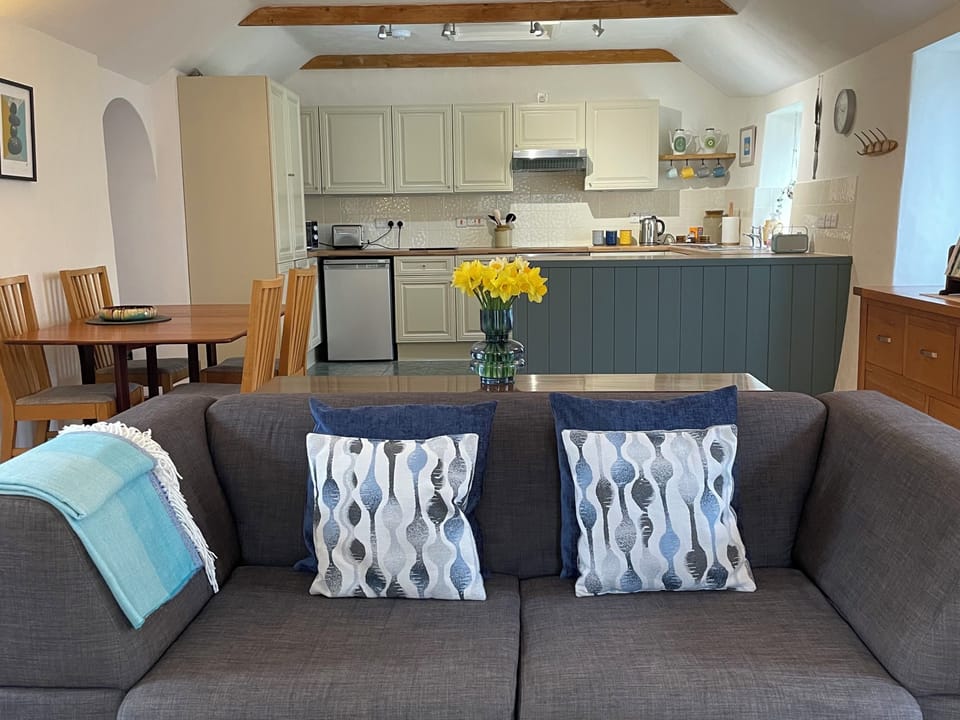 Spacious open plan living area, with defined cooking, dining and seating area