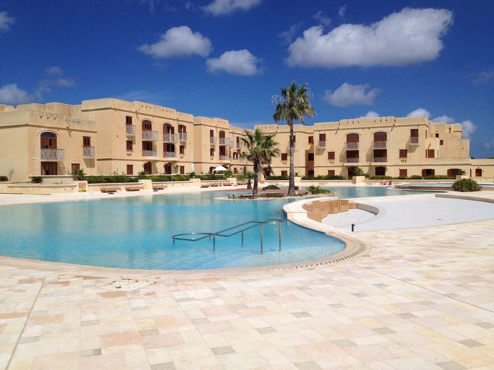 Fort Chambray pool area with loungers, umbrellas and towels provided. 