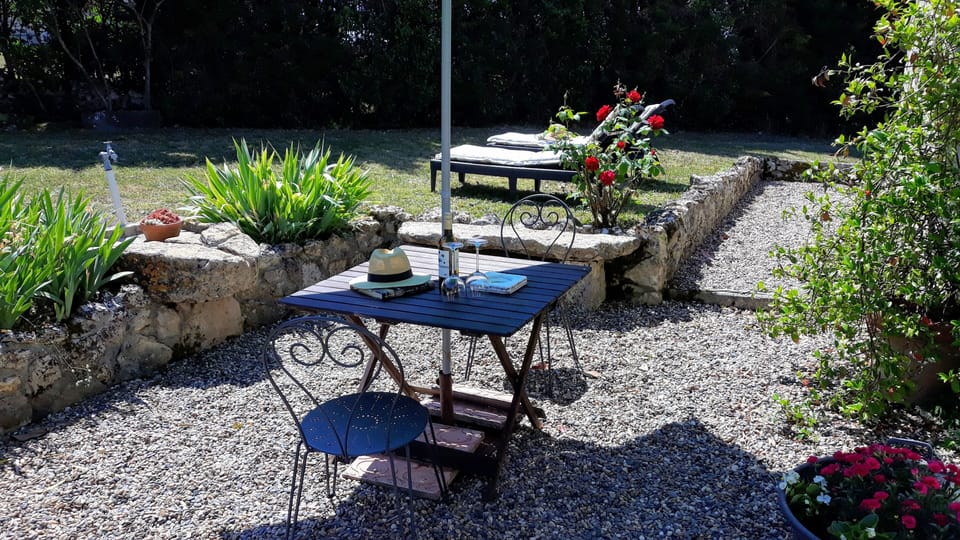 Sunny terrace with essential parasols for shade. Good reads highly recommended.