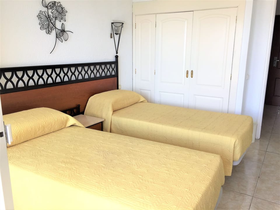 Bedroom with twin beds and built in wardrobe
