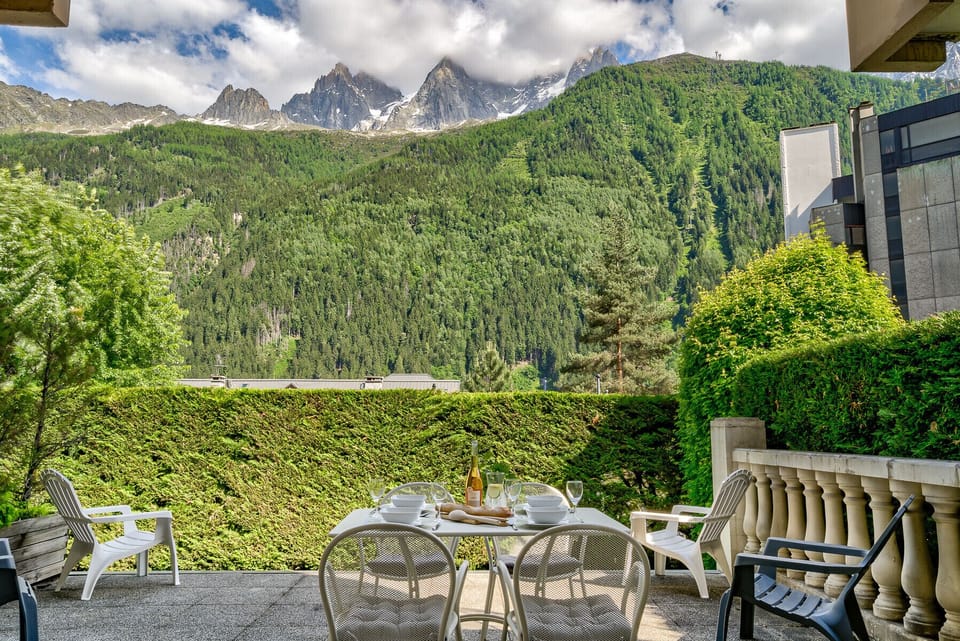 Large terrace with dining furniture and outdoor armchairs