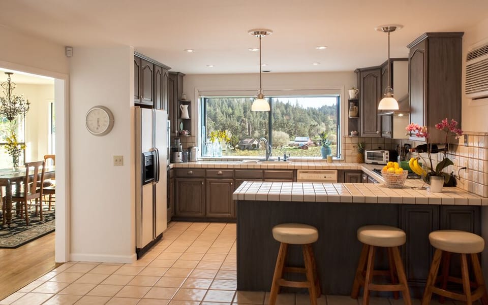 The large, open kitchen with amazing views invites cooking and dining in.