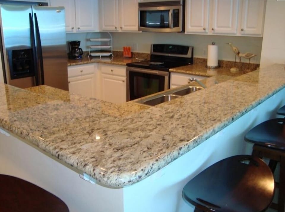 Well equipped kitchen with granite countertops and stainless steel appliances