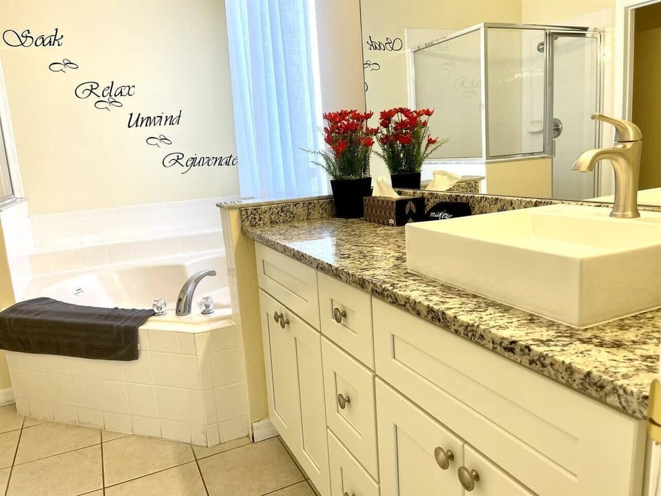 Master bedroom on ground floor with shower, jetted tub, large countertops