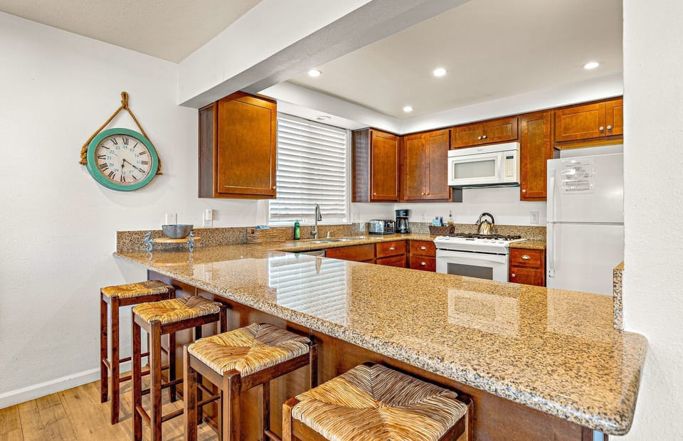 Breakfast bar seating overlooks kitchen headquarters.
                