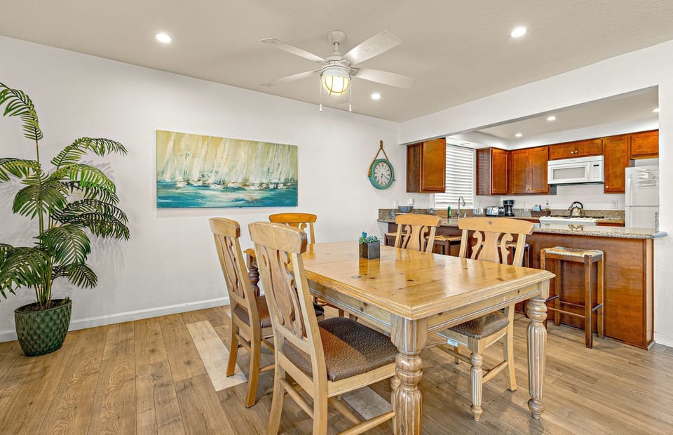 Large family dining table sits adjacent to the kitchen on one side and living room on the other. Perfect for meals, game nights and great conversation!
                