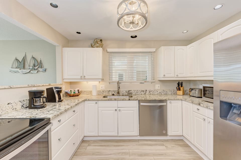 Fully equipped kitchen with granite countertops and stainless steel appliances