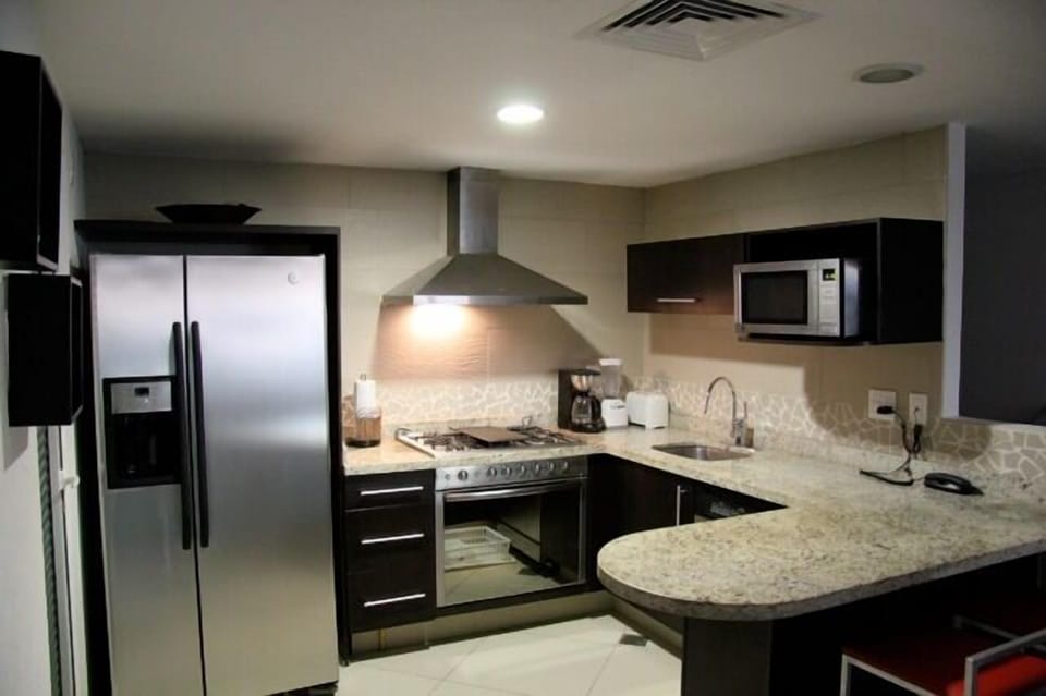 Spacious kitchen has modern stainless appliances and granite tops