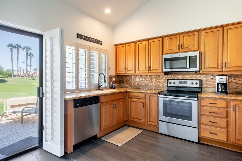 Kitchen opens up to the back patio.  Fully stocked with cooking supplies.
