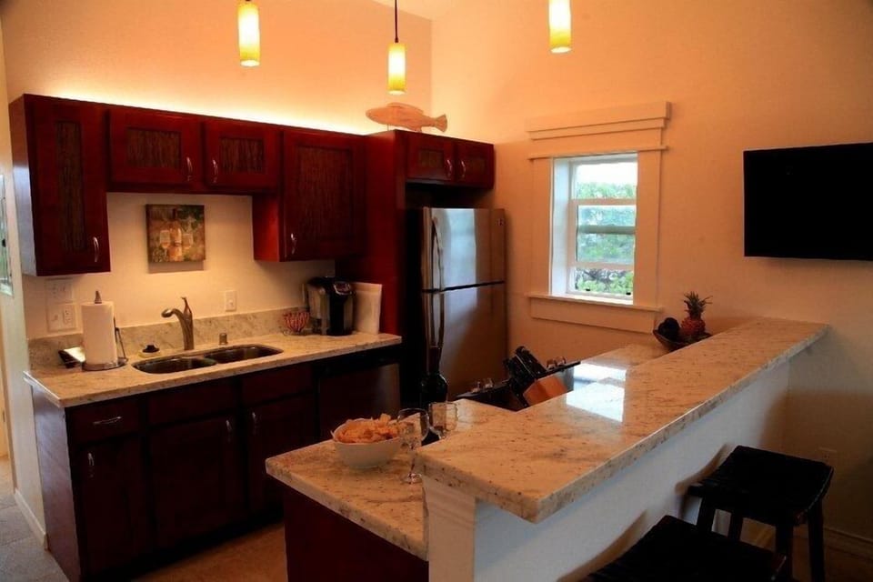 Roomy kitchen with full amenities and ocean view window. 
