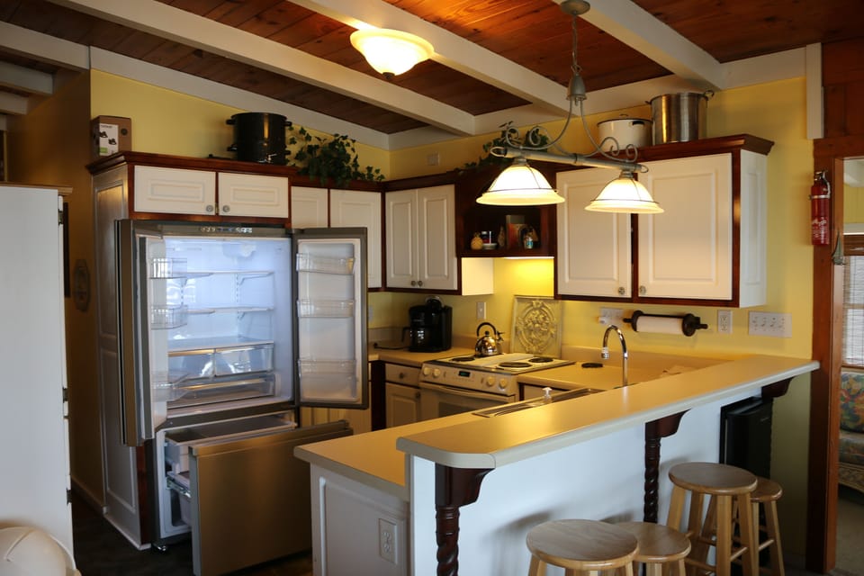 Ocean views from Kitchen, overlooks dining area with bar seating. New Frig.
