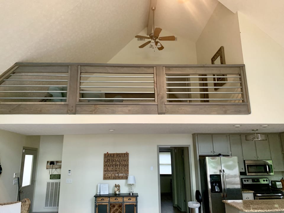 Loft area overlooking wall of windows